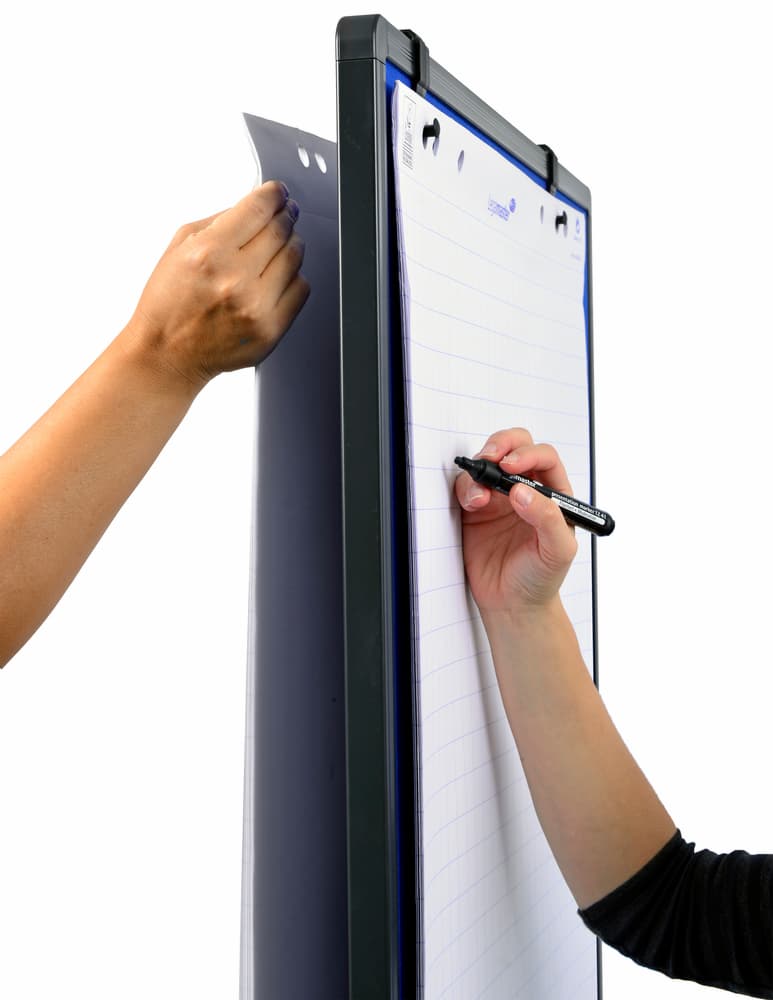 Two people use a Legamaster workshop board paper hook; one peels off a lined sheet while the other writes with a black marker on the next page. The white background highlights the Legamaster flip chart product in action.